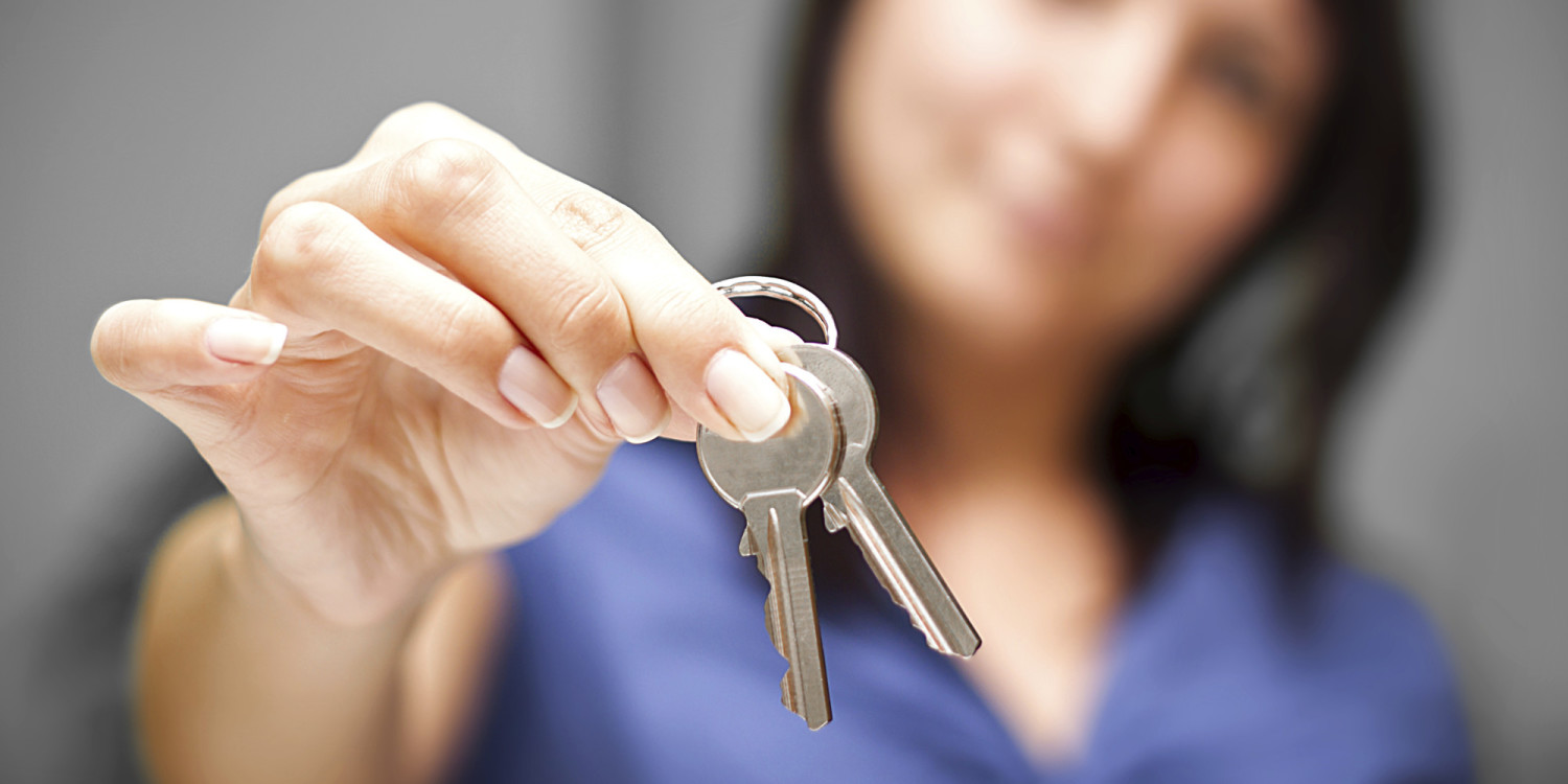 Realtor in empty apartment giving keys